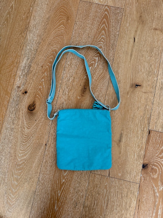 Teal Kipling purse with monkey keychain